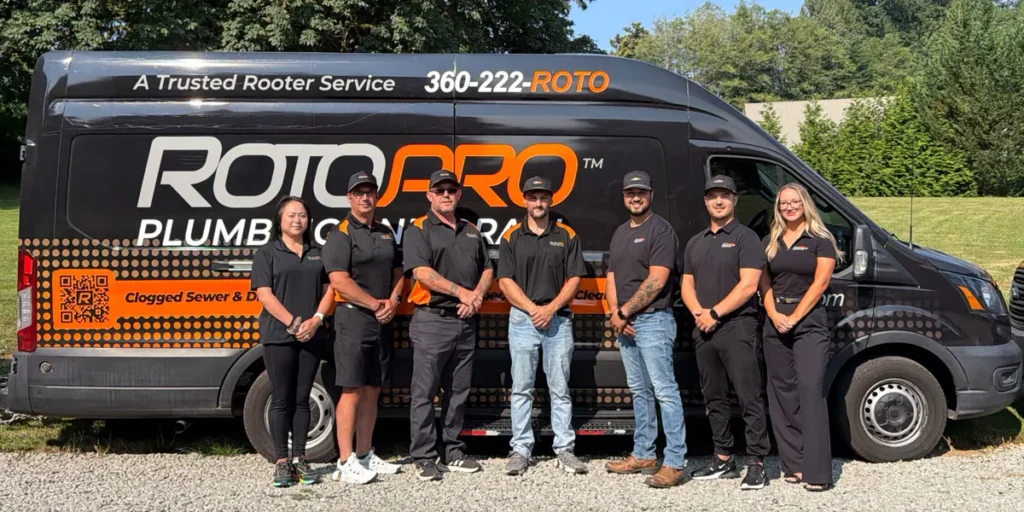 Staff standing next to the company van