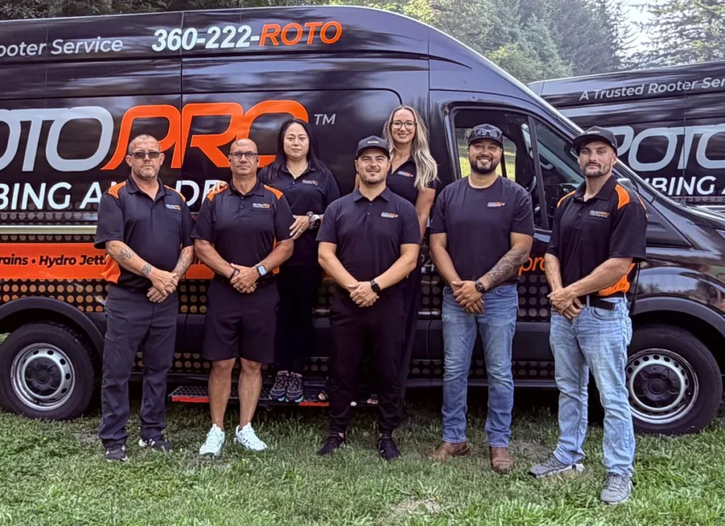 Roto Pro staff posing in front of the company van