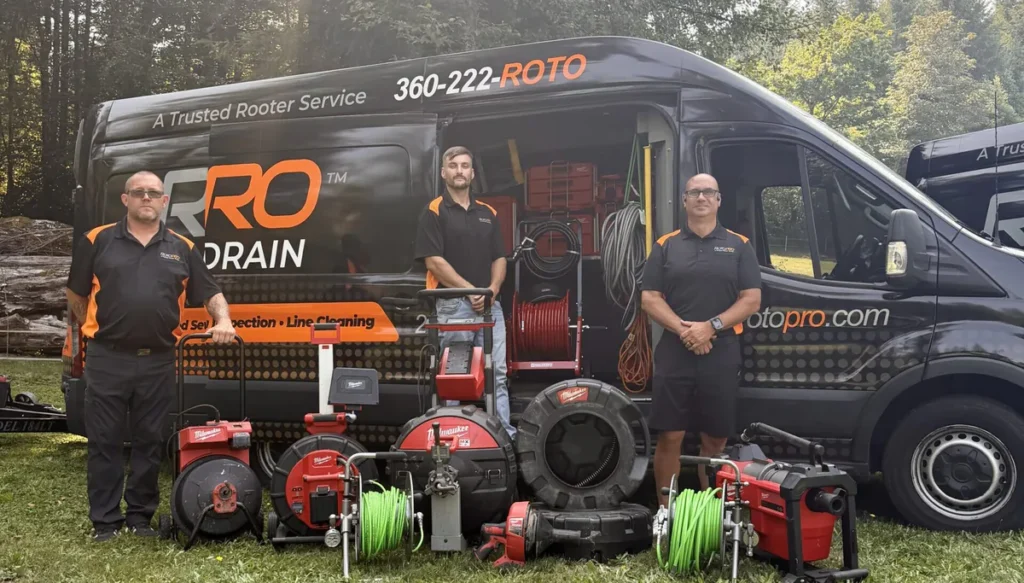 Roto Pro staff member standing in front of the company van with operating tool