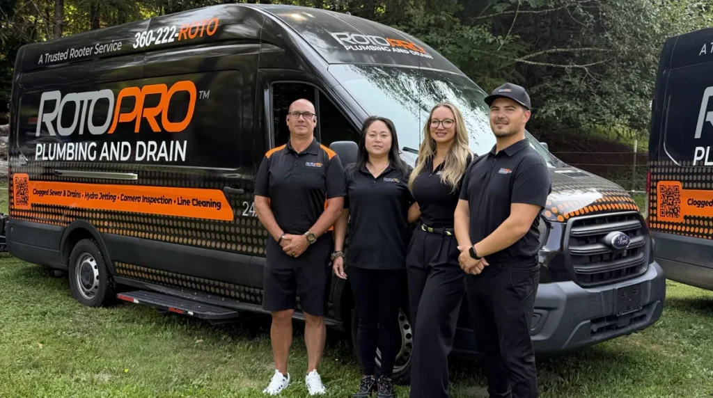 Roto Pro staff members standing in front of the company van