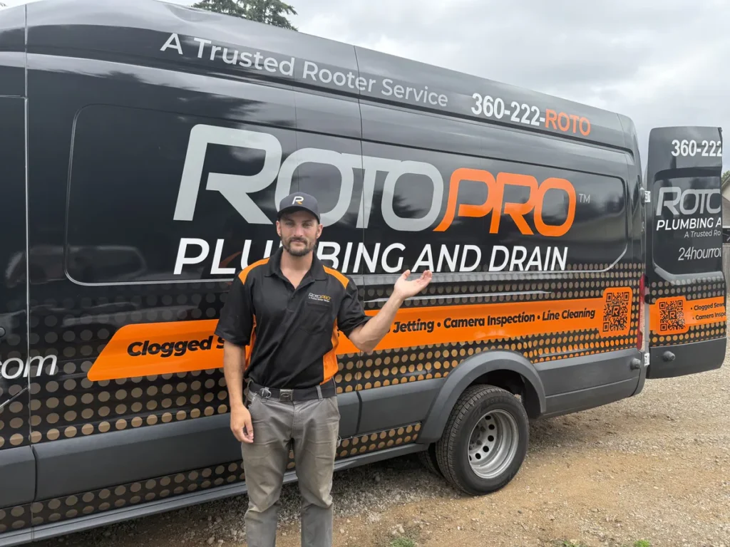 Roto Pro staff member standing in front of the company van