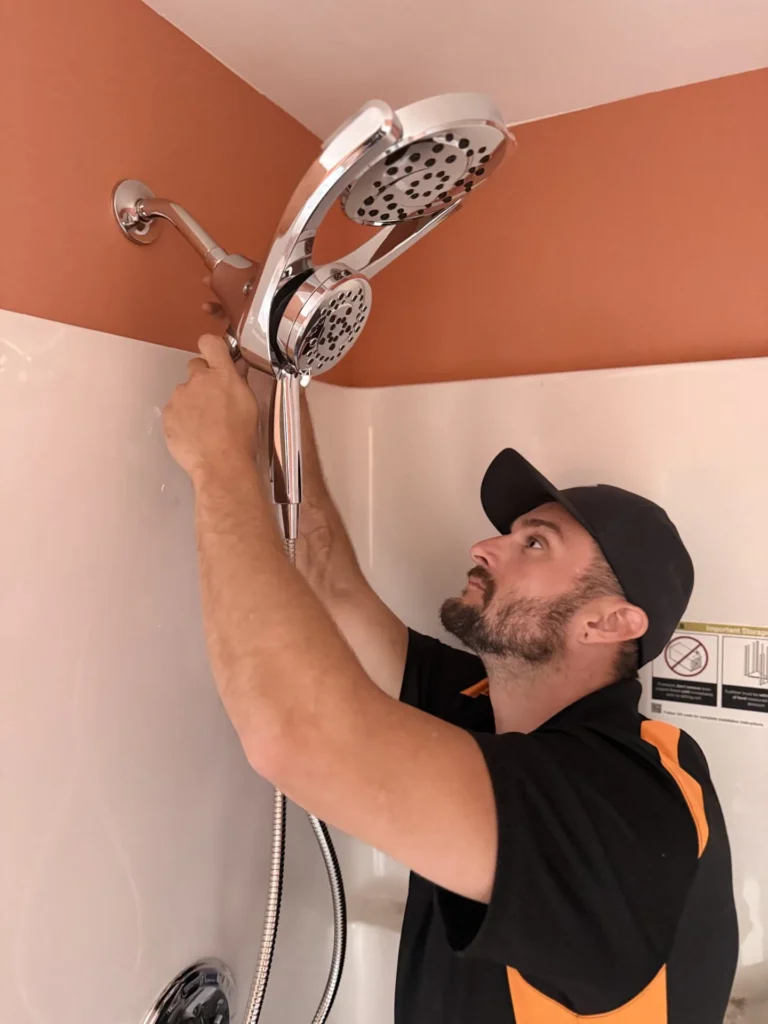 Plumber fixing a shower head